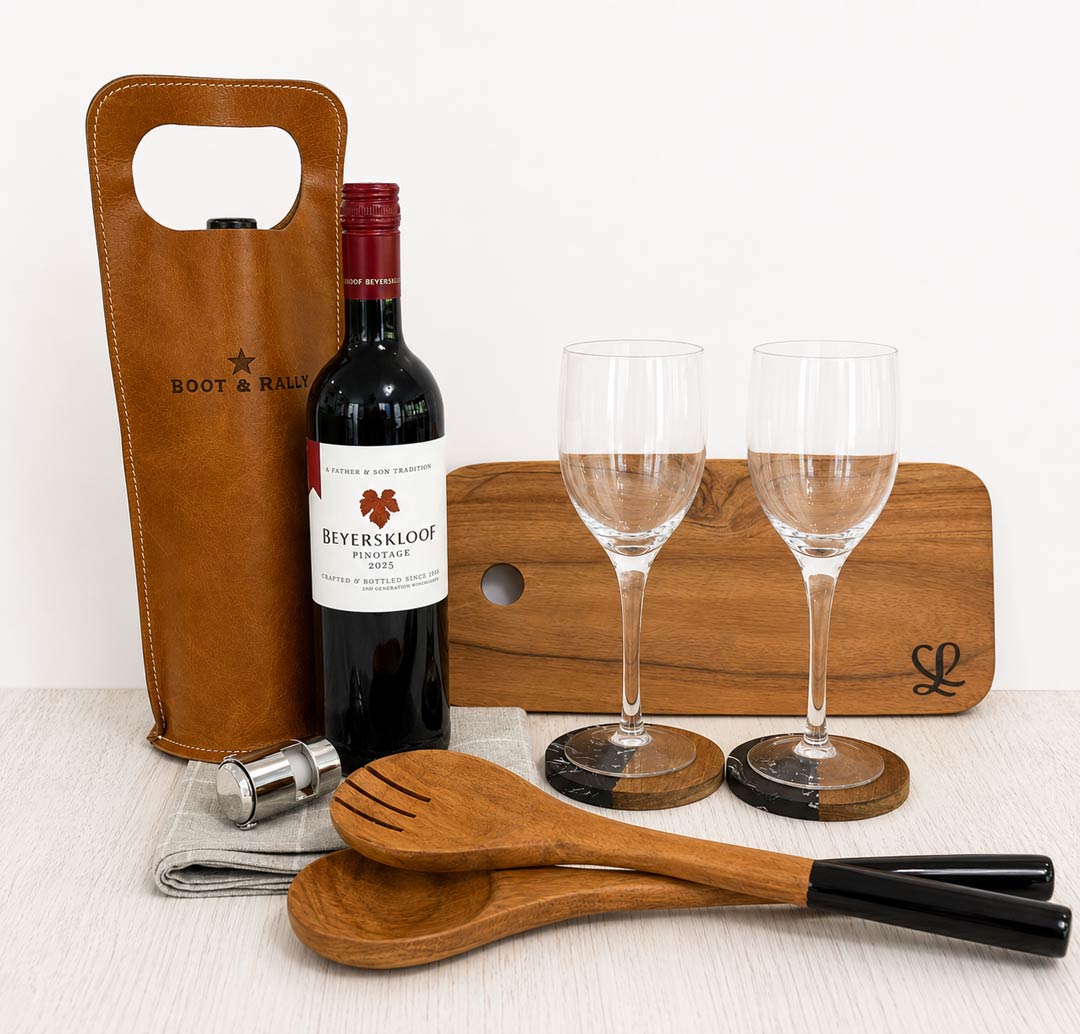 The Home & Vine luxury housewarming gift box with red wine, two wine glasses, wooden serving board, salad servers and leather wine carrier